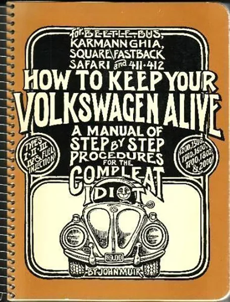 Portada vintage de manual de reparación Volkswagen con encuadernación naranja e ilustración frontal de un Beetle